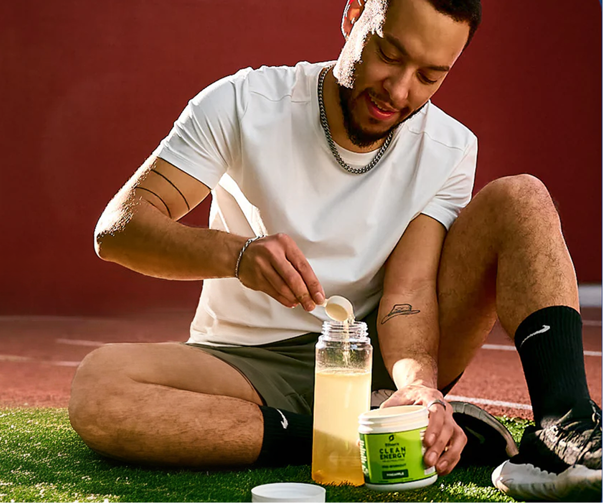Athlete mixing pre-workout on the track