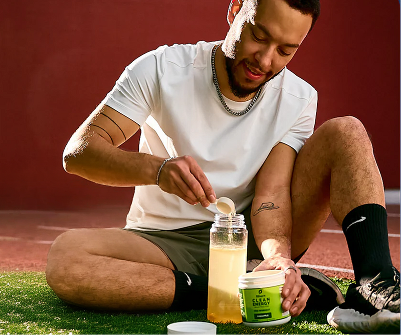Athlete mixing pre-workout on the track
